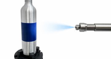 Representative image of Nordson spray onto aluminium bottle